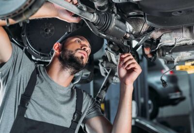 mechanic in overalls repairing car in auto repair 2021 08 29 22 51 18 utc 1 1080x675 1